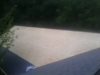 New OSB roof sheathing installed beside an existing shingle roof in Cedar Park